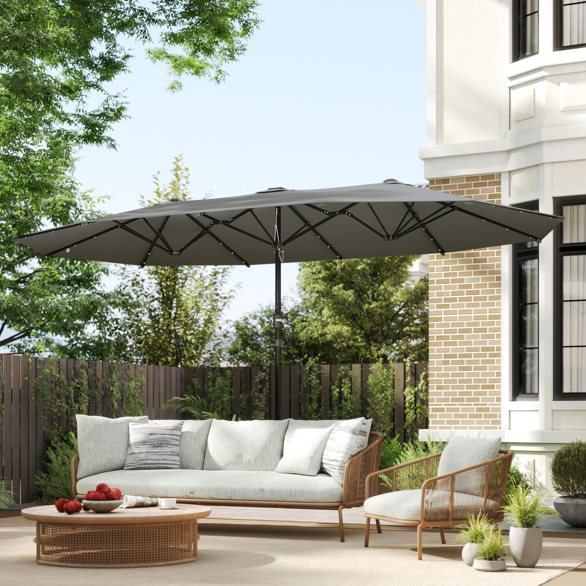Dark gray double-sided patio umbrella shading an outdoor seating area