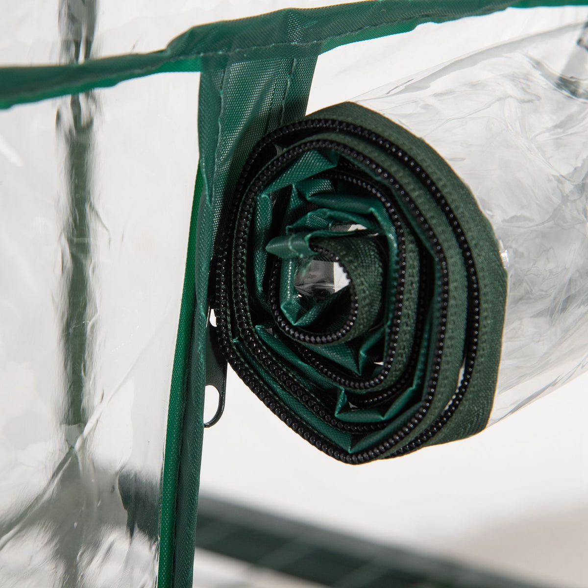Outsunny greenhouse roll-up door rolled and secured at the top