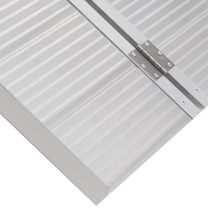 Close-up of the wheelchair ramp's ridged surface and center hinge