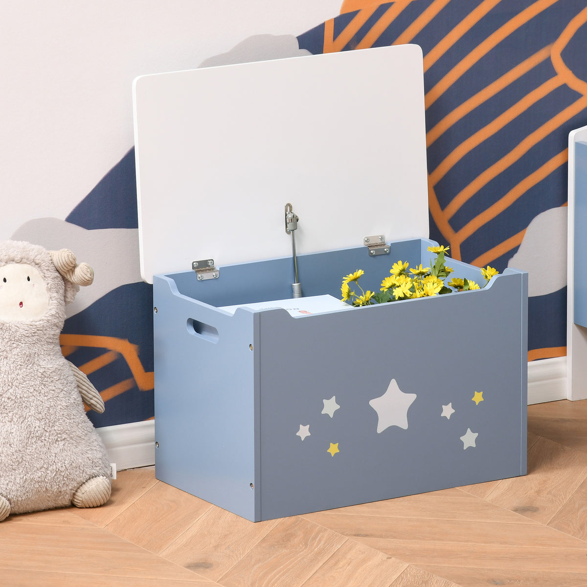 Open blue toy chest with safety hinge, side handles, and star decals