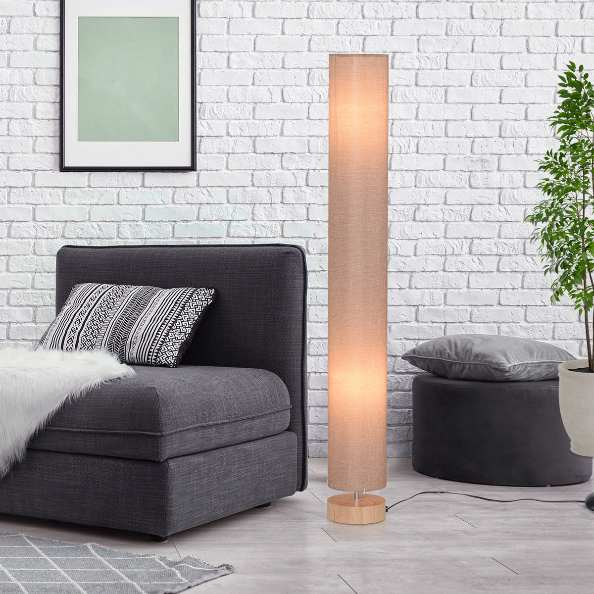 HOMCOM floor lamp glowing through its cylindrical linen shade, with a round wooden base.