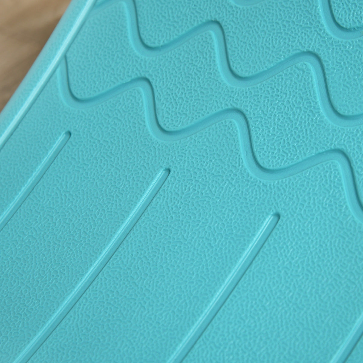 Close-up of textured blue balance board surface with raised grip patterns