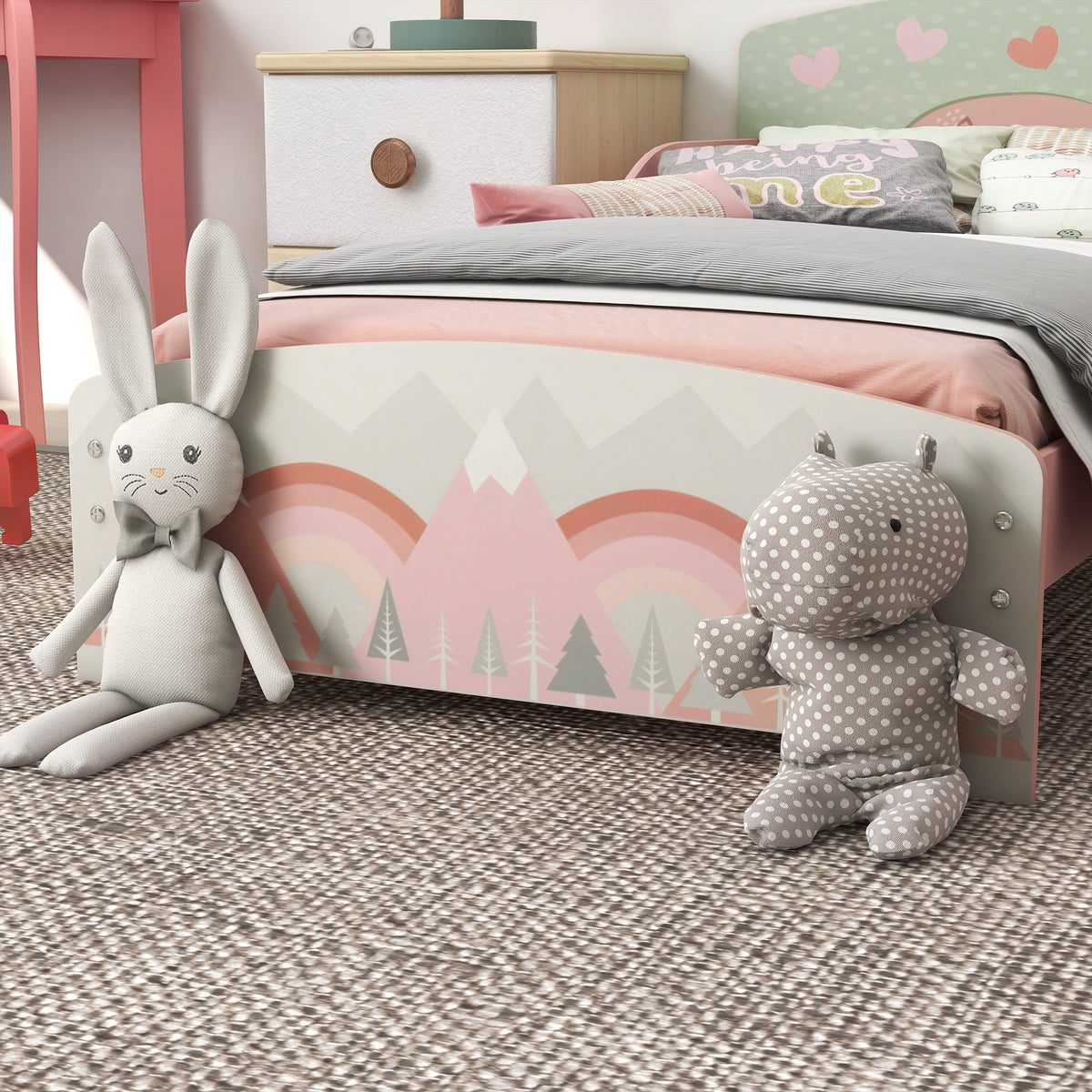 Close-up of toddler bed footboard with pastel mountain print and rounded corners