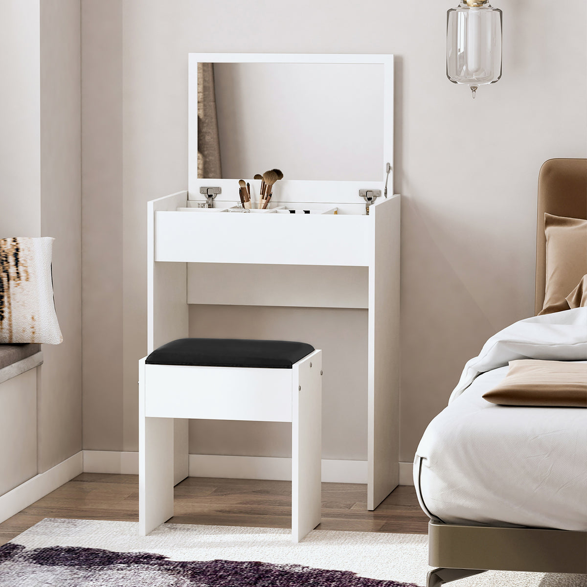 White dressing table with large mirror, open storage compartments, and black padded stool