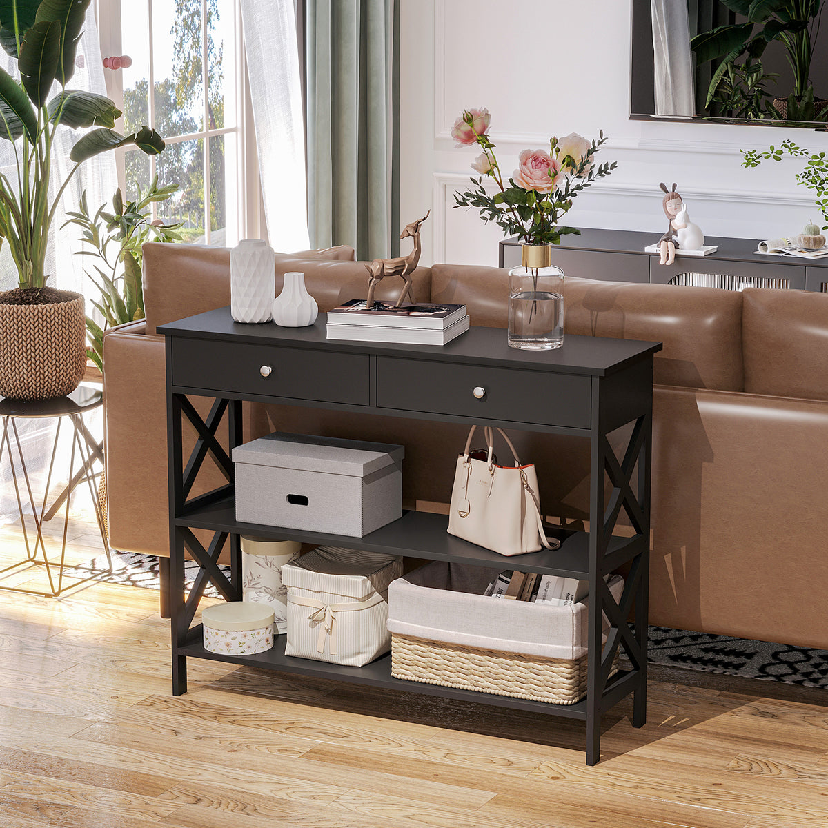 Black console table with two drawers and two shelves, styled with storage baskets and decor.