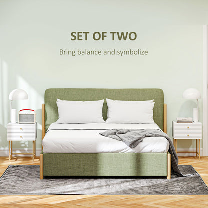 White bedside tables with gold-tone legs, shown as a matching pair beside a bed