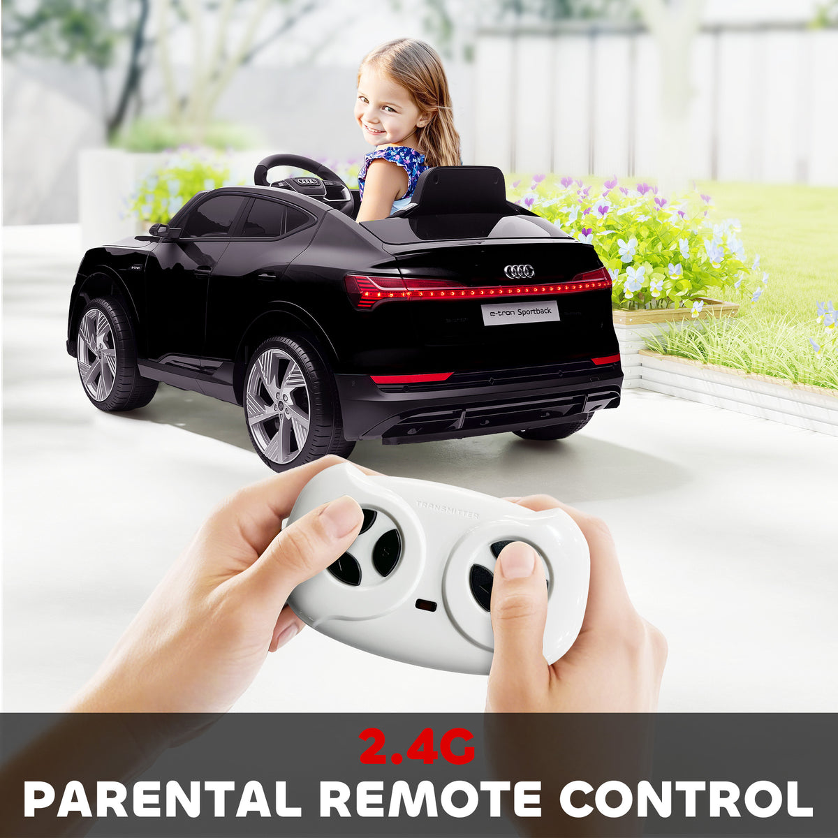 Black Audi e-tron kids' ride-on car with a handheld parental remote control.