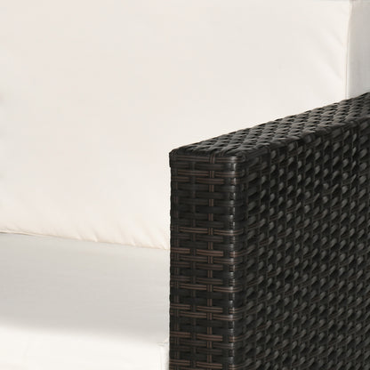 Close-up of the woven rattan armrest beside the white cushions