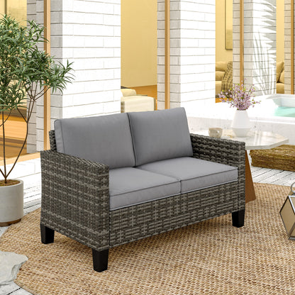Outsunny two-seat wicker sofa with gray cushions in an outdoor setting