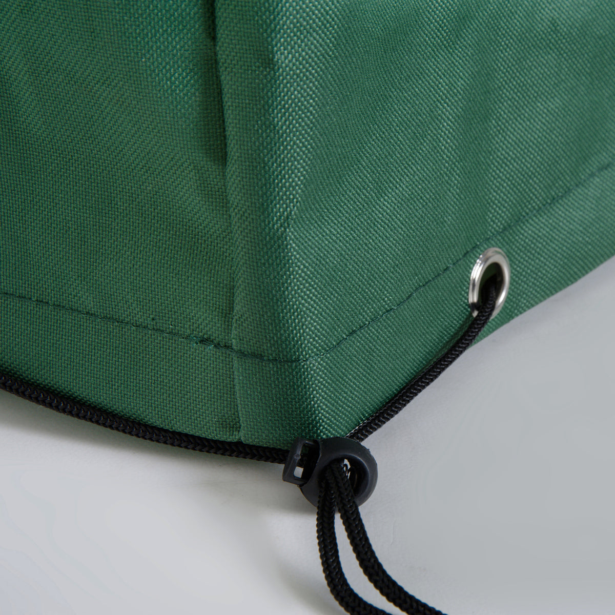 Green furniture cover corner with reinforced eyelet and adjustable drawcord