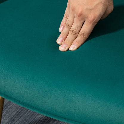 Dark green upholstered armchair seat with soft velvet-feel fabric under a hand