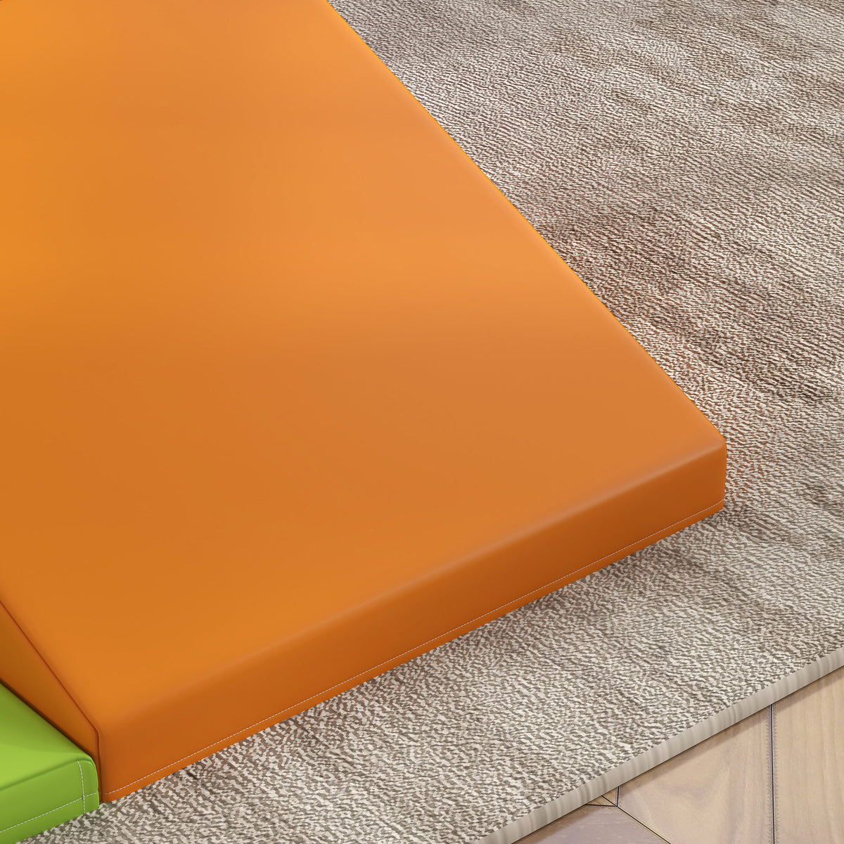 Close-up of the orange foam play set ramp with a smooth cover and raised edge