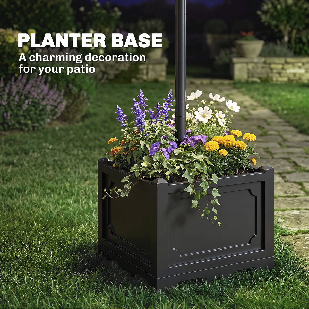 Black square planter base filled with flowers beneath a lamp post
