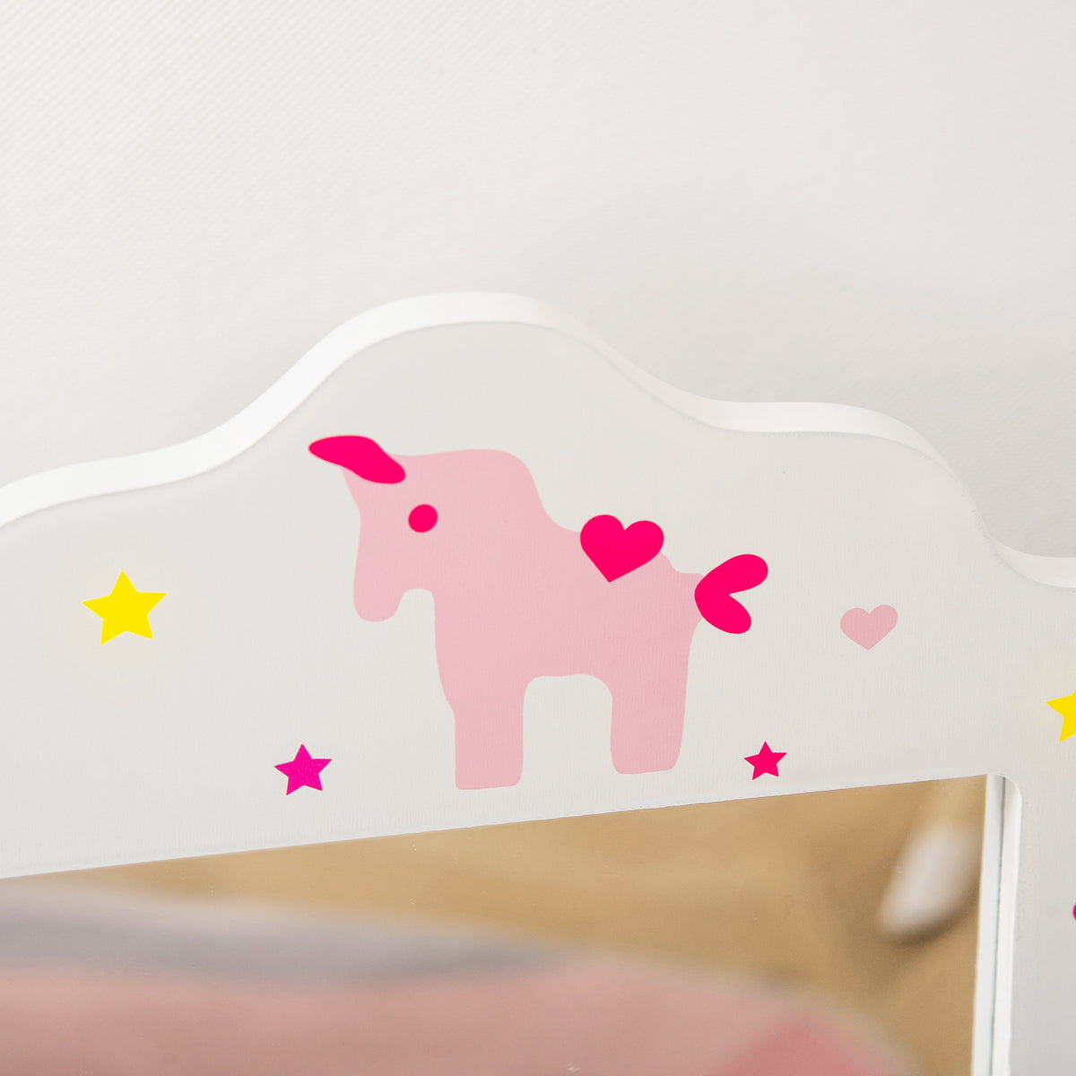 Close-up of white vanity mirror frame with pink animal and heart decals