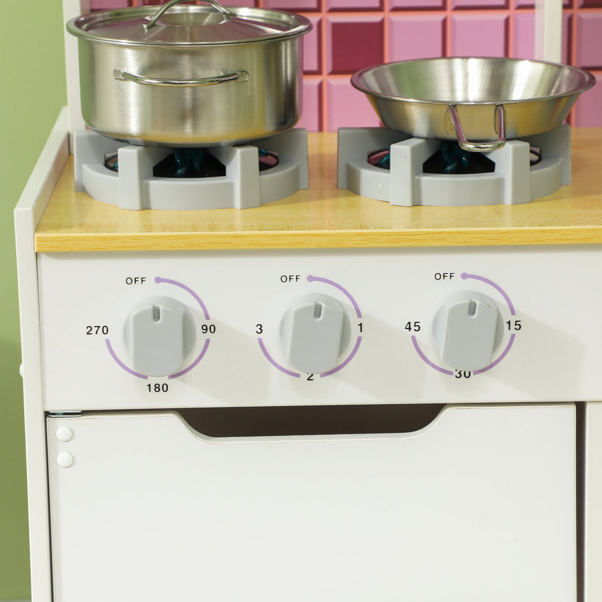 AIYAPLAY play kitchen close-up of two burners, cookware and three stove control knobs