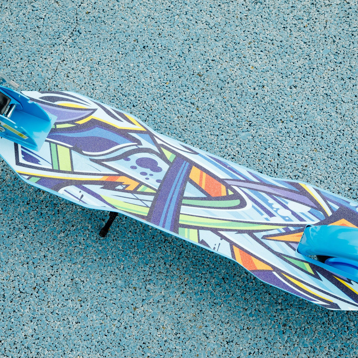 Close-up of the scooter deck with a colorful geometric graphic.