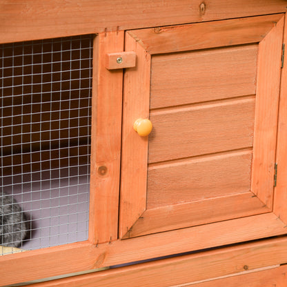 PawHut wooden hutch door with round knob, latch, and adjacent wire mesh