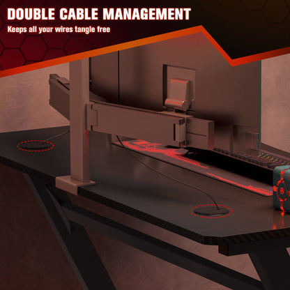 Black gaming desk with dual cable management openings and rear cable tray