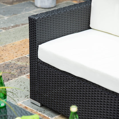 Close-up of a black woven rattan chair with a cream seat and back cushion