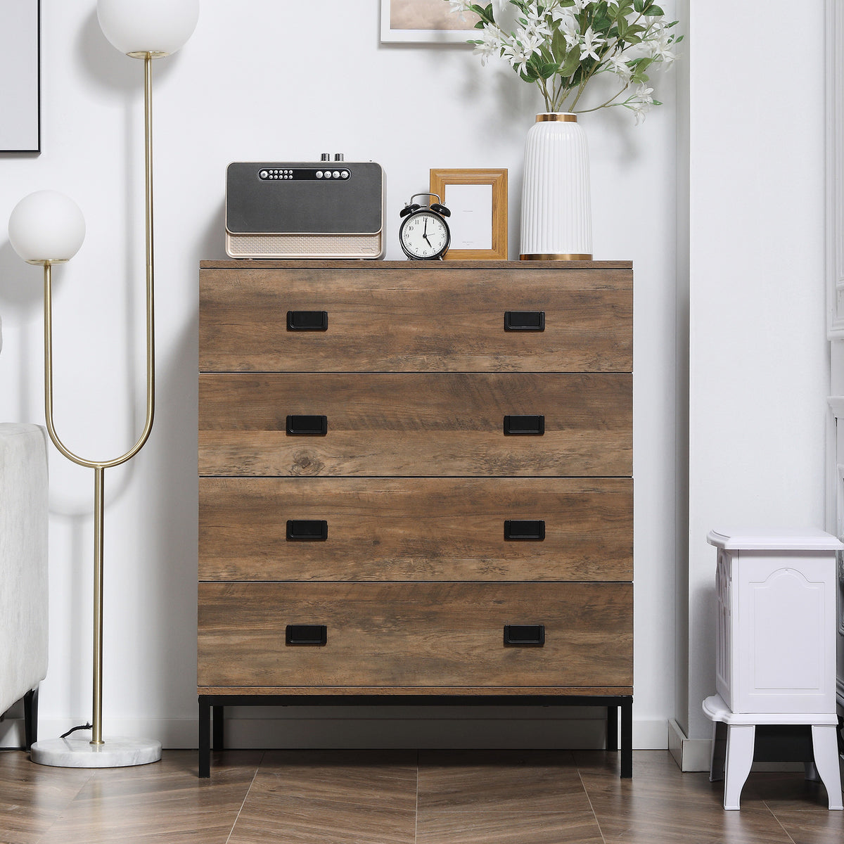 Front view of a brown four-drawer chest with black handles and metal legs