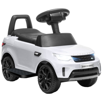 White Land Rover kids' ride-on car with black seat, steering wheel, and chunky wheels