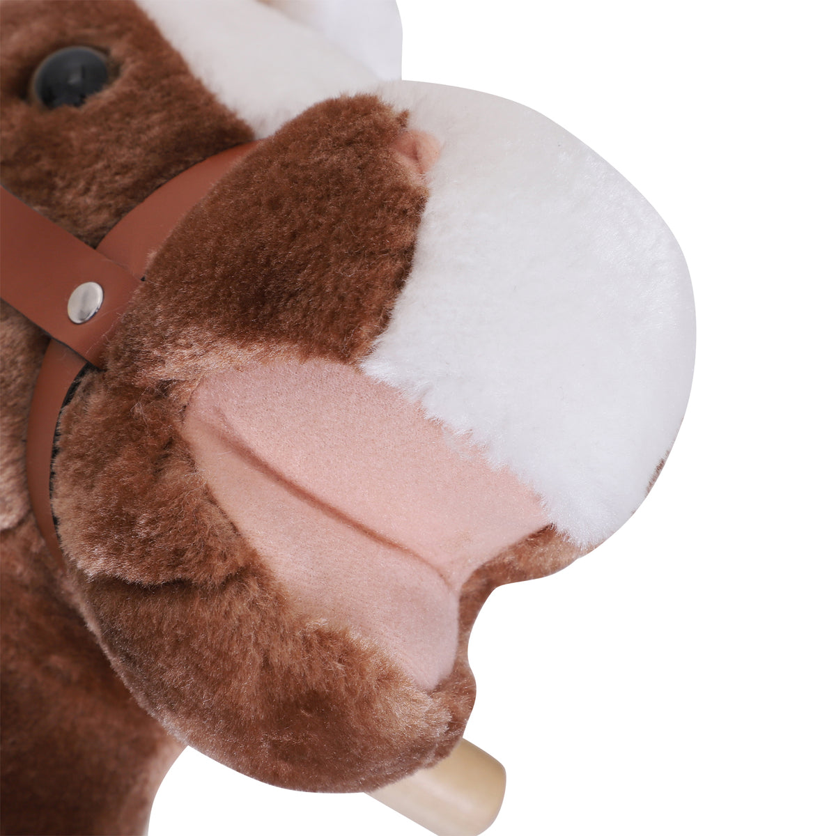 Close-up of plush rocking horse muzzle, bridle and wooden handle grip