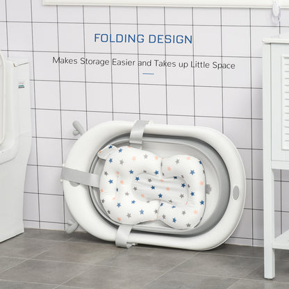 Foldable baby bathtub secured with straps around its star-print cushion