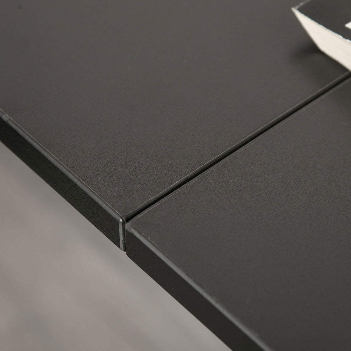 HOMCOM desk close-up showing the black melamine surface and joined tabletop edges