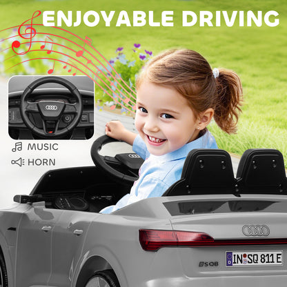 Grey Audi ride-on car shown from the rear with a child at the wheel