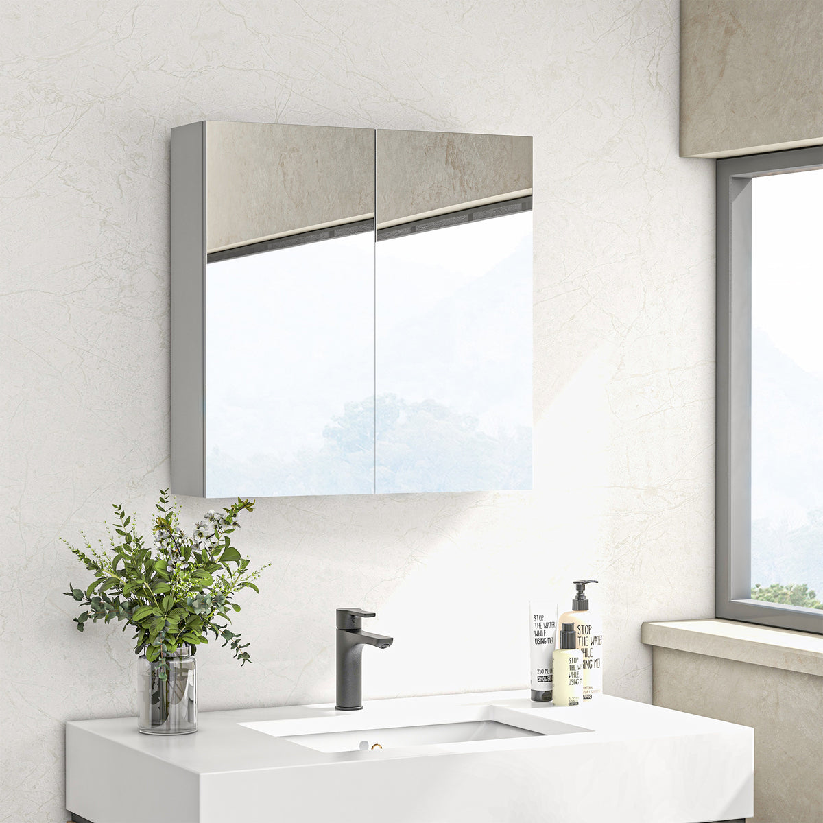 Two-door mirrored bathroom cabinet mounted above a sink