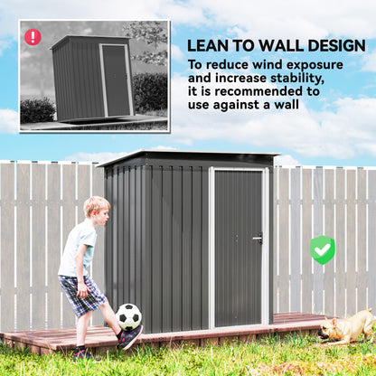 Outsunny garden shed with sliding door and sloped roof, shown against a fence