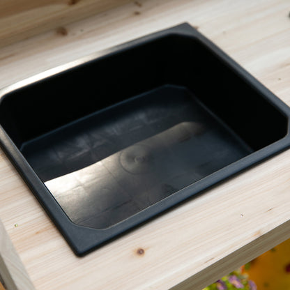 Black removable sink inset into the wooden potting bench worktop