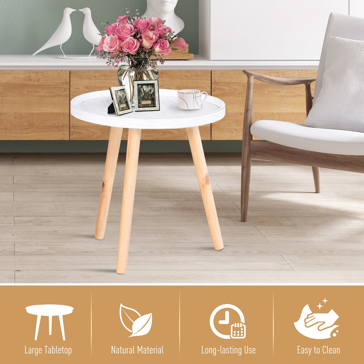 Round white coffee table with carved top and wood legs, shown beside a chair