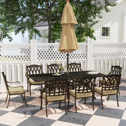 Bronze-tone garden dining set with eight cushioned chairs and a rectangular ornate table