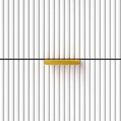 Close-up of the bedside table's gold-tone handle on a fluted drawer front