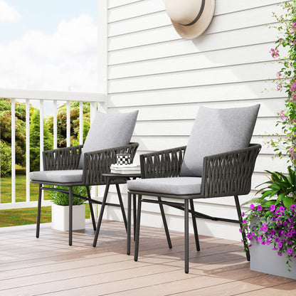 Grey rattan bistro set arranged with two cushioned chairs and table