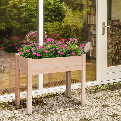 Outsunny raised wooden planter filled with pink flowers beside a patio door