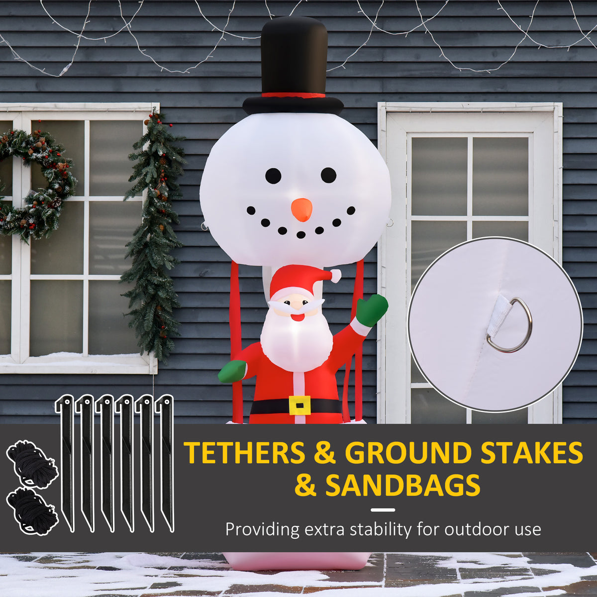 Santa and snowman inflatable decoration with tether loops, ground stakes, and sandbags
