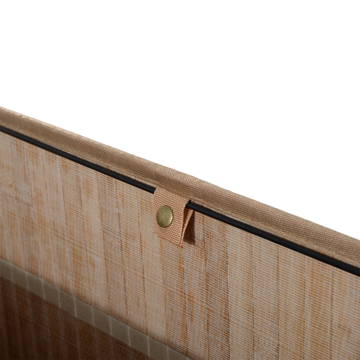 Close-up of a woven fabric hamper edge with a fastening tab