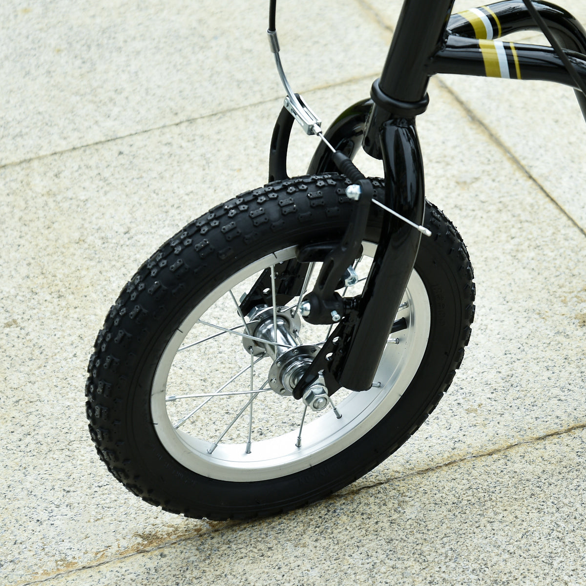Close-up of the scooter's knobby front tire, spokes, and brake assembly