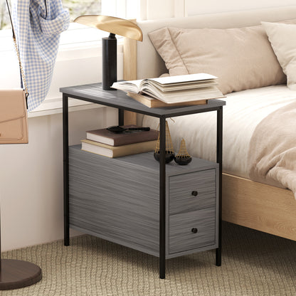 Grey wood-grain bedside table with two drawers and open shelf beside a bed