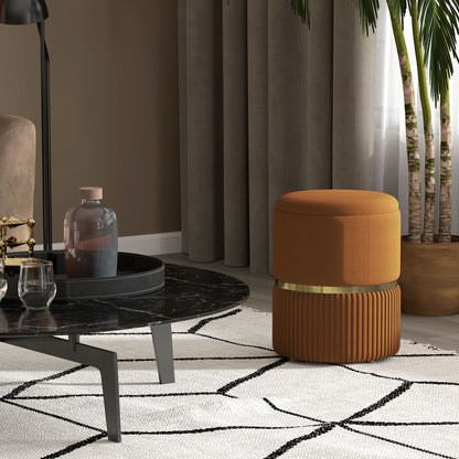 Brown velvet-feel ottoman with a smooth lid, gold-tone band, and fluted base