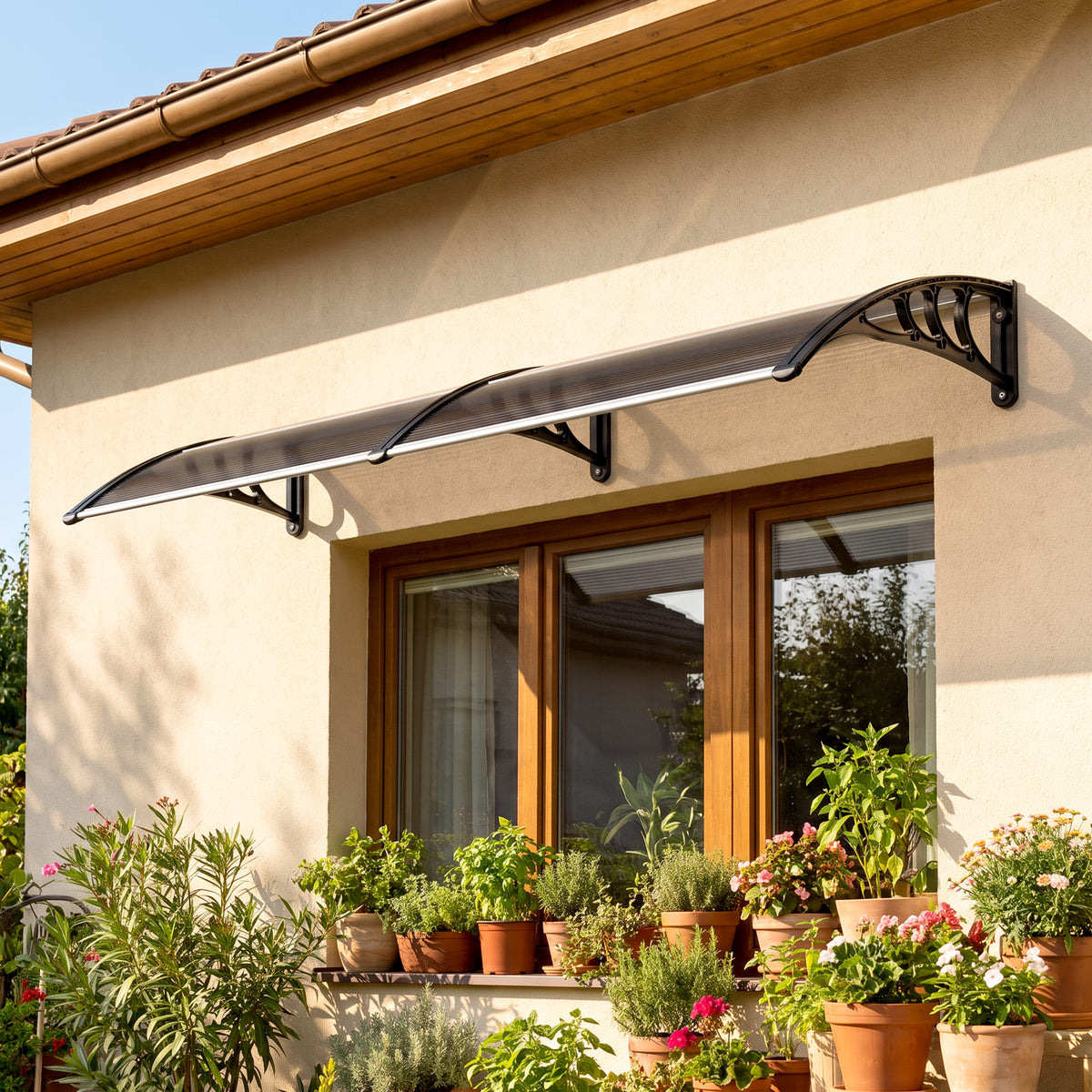 Outsunny black curved door canopy installed above a glazed exterior doorway