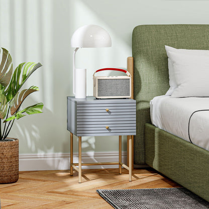 Grey HOMCOM bedside table with two ribbed drawers and slim gold-tone legs beside a bed