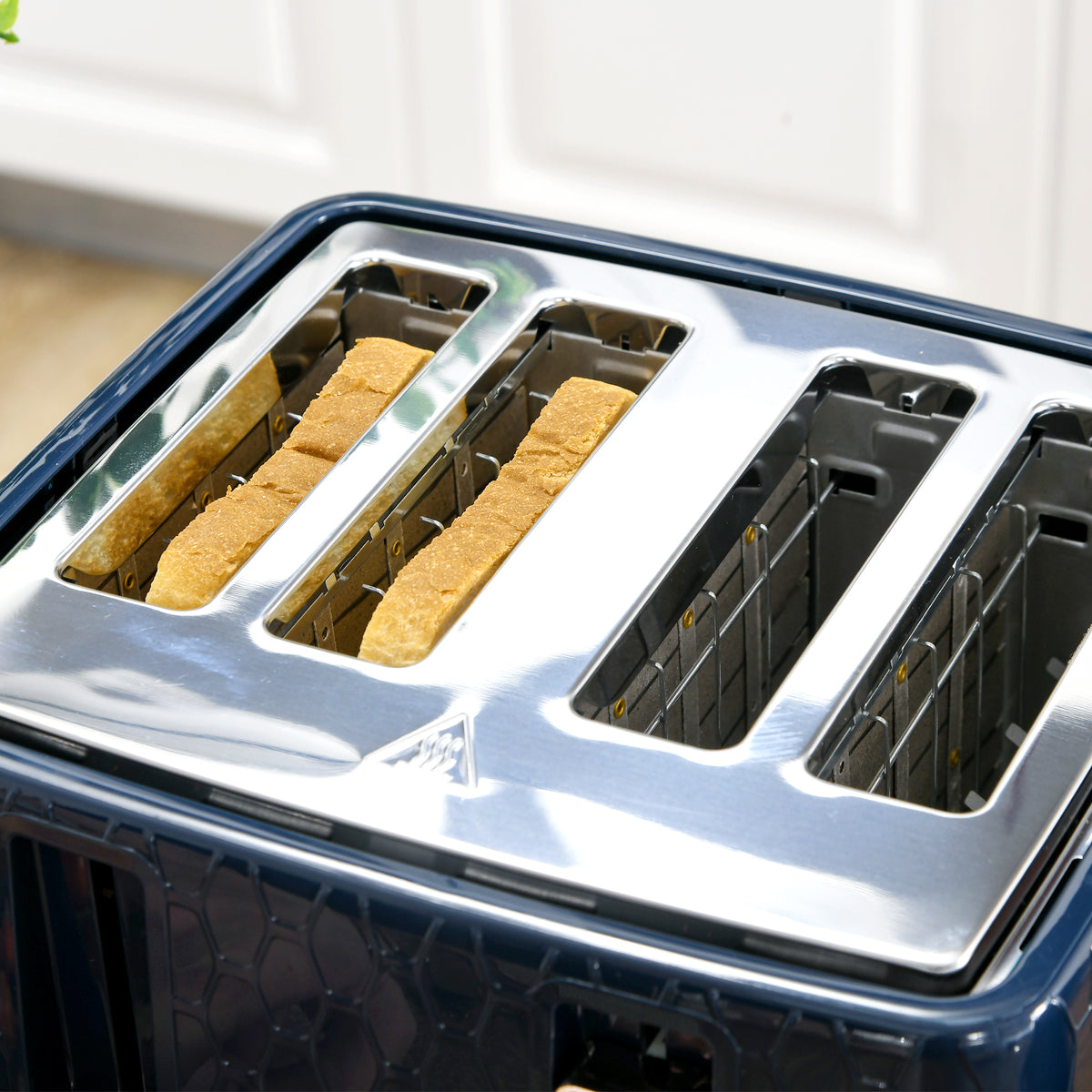 Four-slice toaster with two slices of bread in its slots