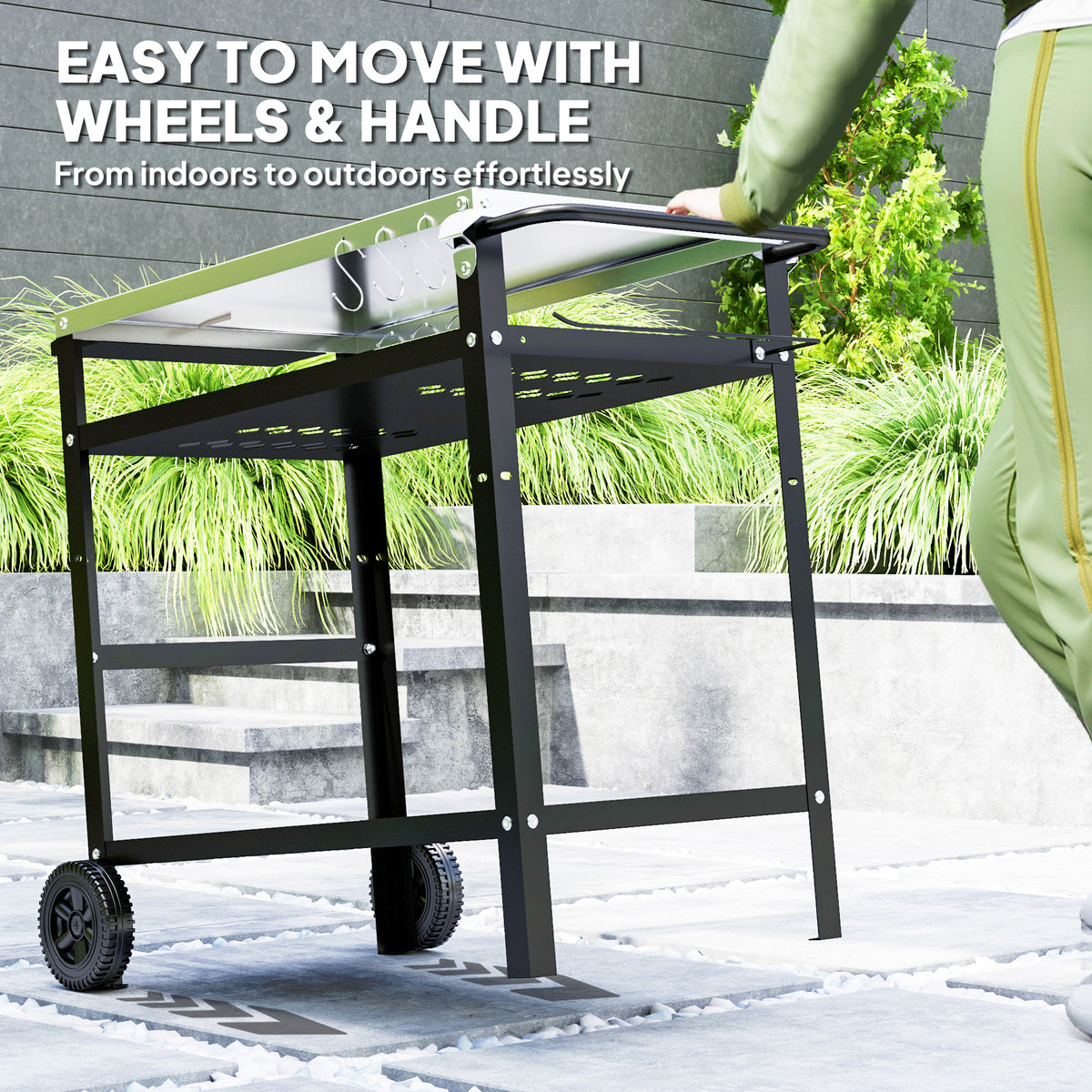 Black barbecue trolley with handle and wheels, shown being moved