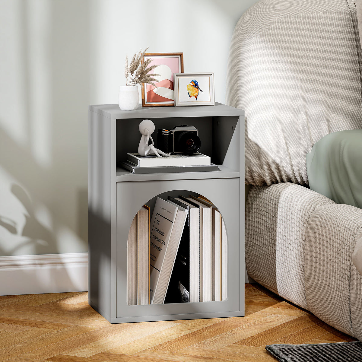 Grey bedside table with an arched lower compartment holding books