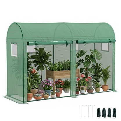 Green walk-in greenhouse with potted plants inside and included stakes and tie-down ropes.