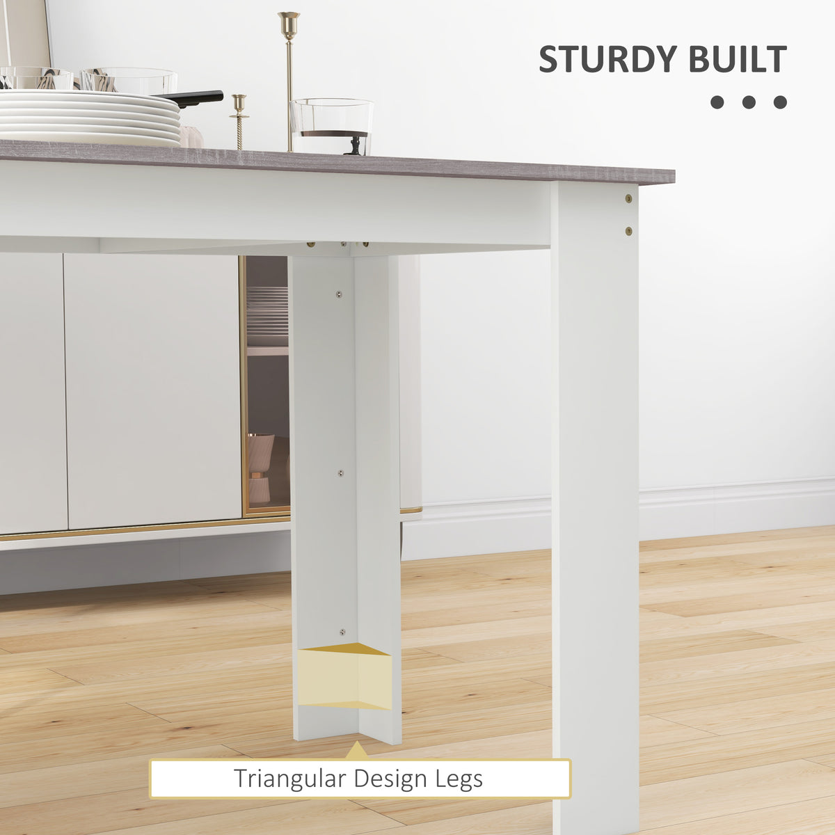 Dining table detail showing sturdy white triangular legs and gray wood-effect top