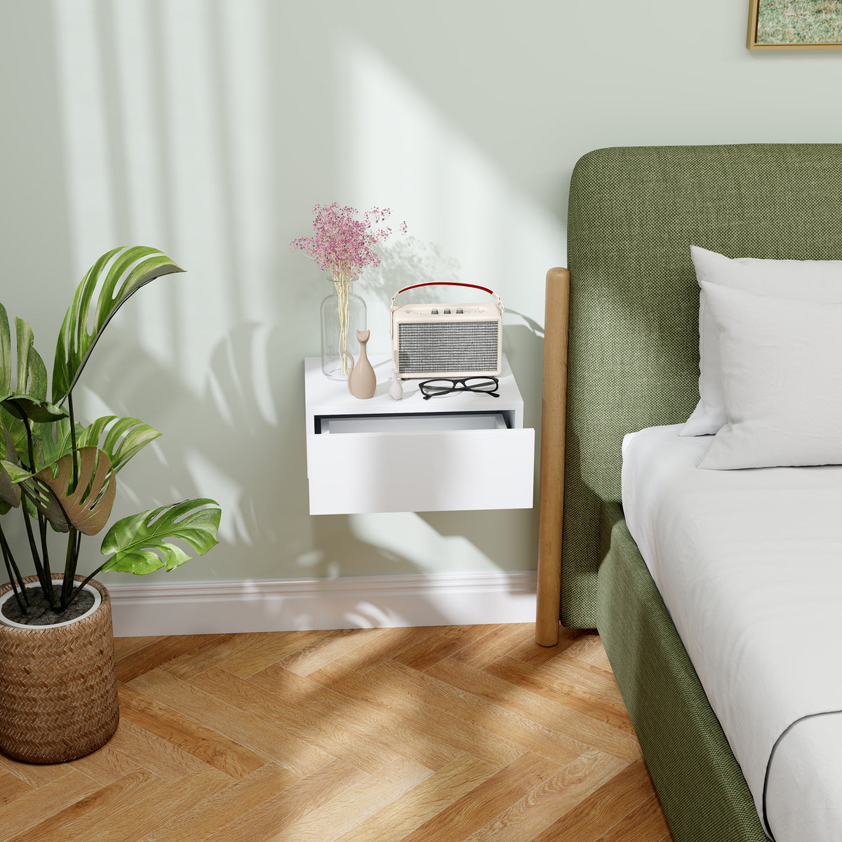 White floating bedside table with a partially open drawer.